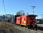 The caboose bringing up the rear of the train as it heads toward Freehold and Jamesburg